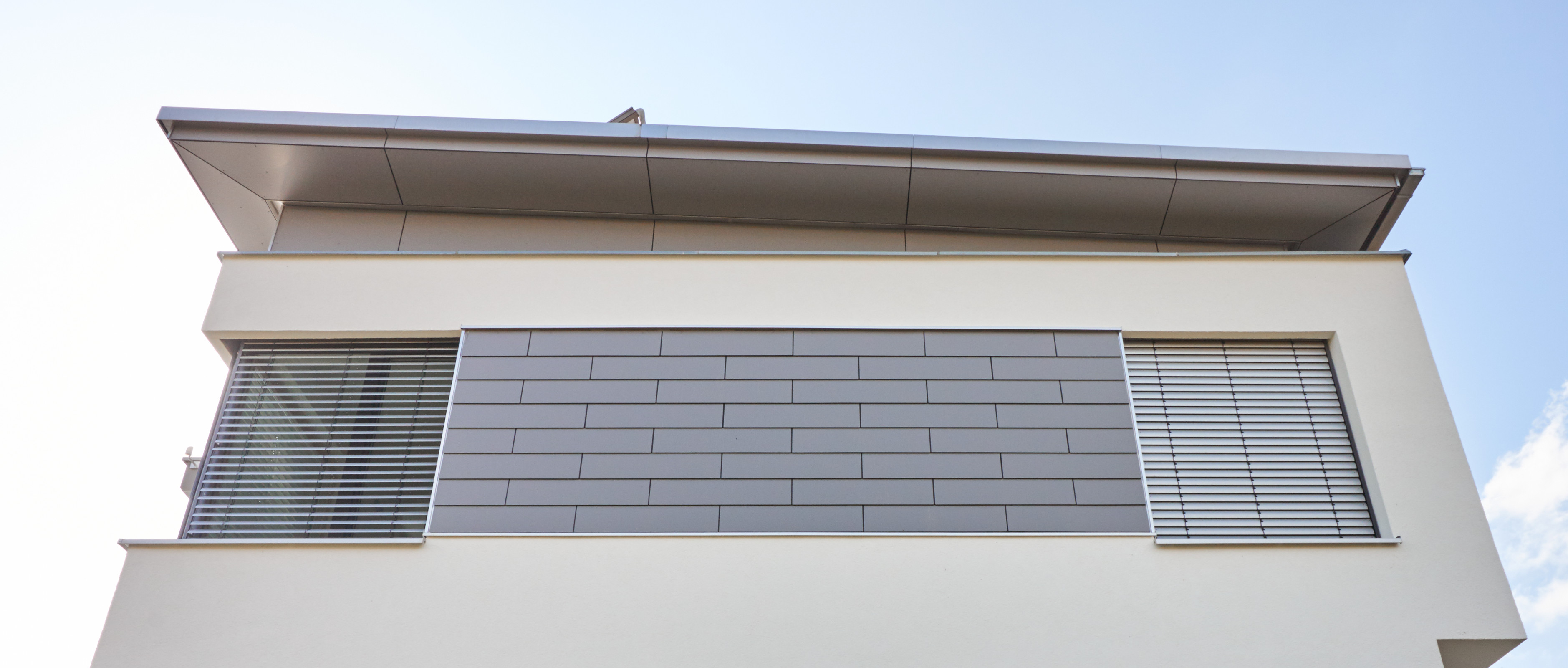 Wandverkleidung mit Pultdachverkleidung mit Fundermax Exterior 0075 grau Stulpschalung